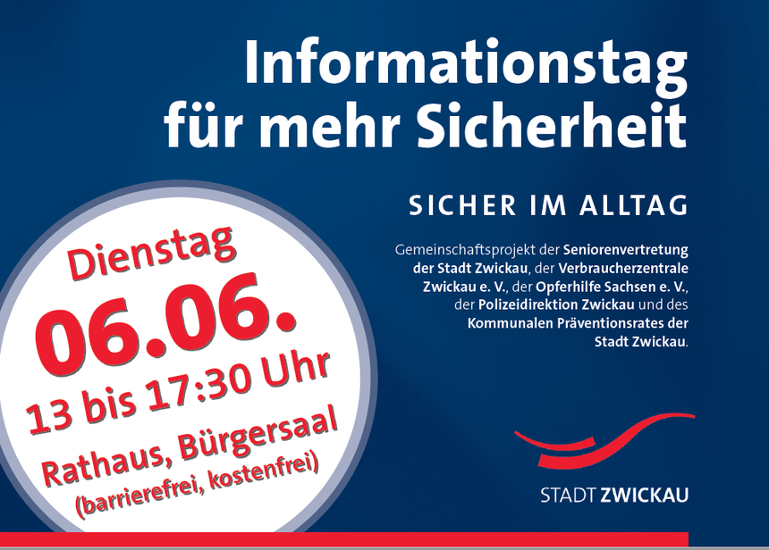 zeigt Flyer mit Aufschrift: Informationstag für mehr Sicherheit